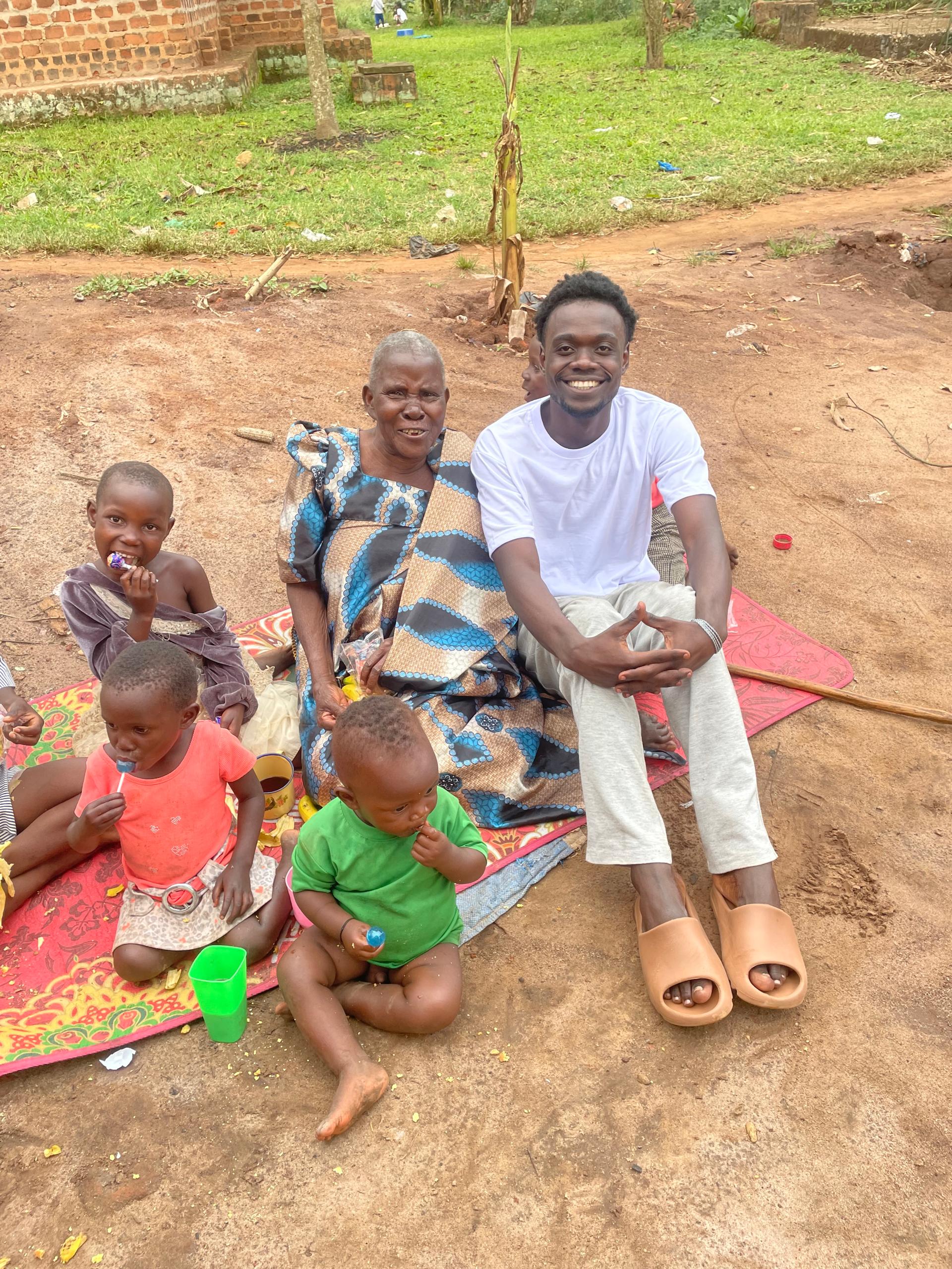 Helping Hands Charity Uganda community members sharing a meal together